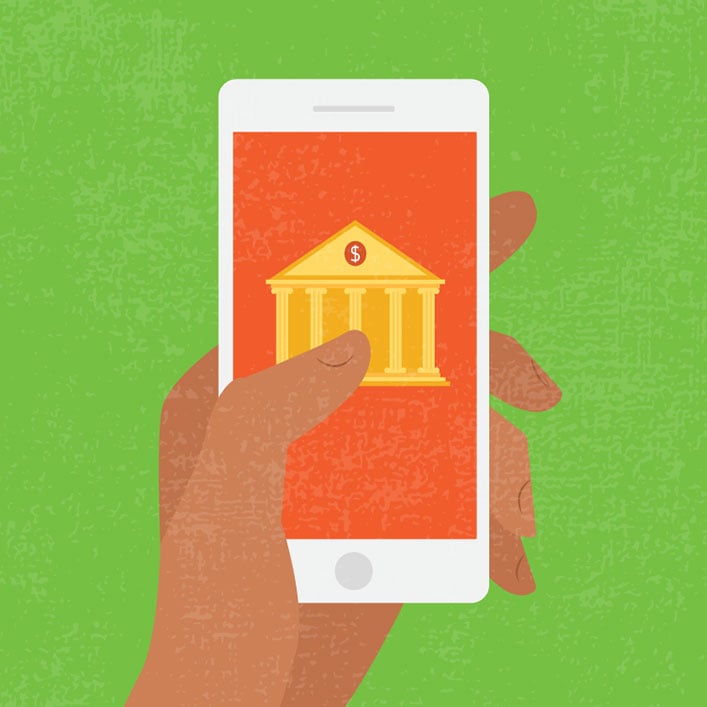 Una mano sosteniendo un teléfono inteligente que muestra un edificio bancario. Mantente conectado con tus finanzas mientras viajas.